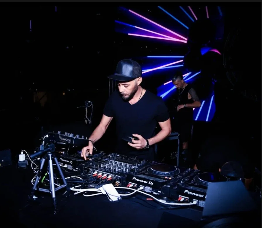 DJ mixing on Pioneer decks under laser lights